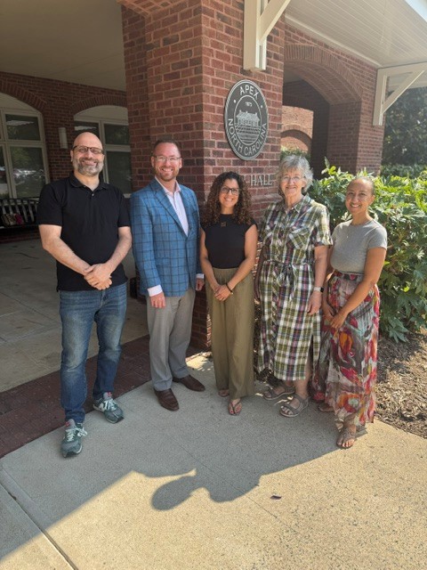 The five founding board members of Peak City Land Trust standing in front of Apex Town Hall